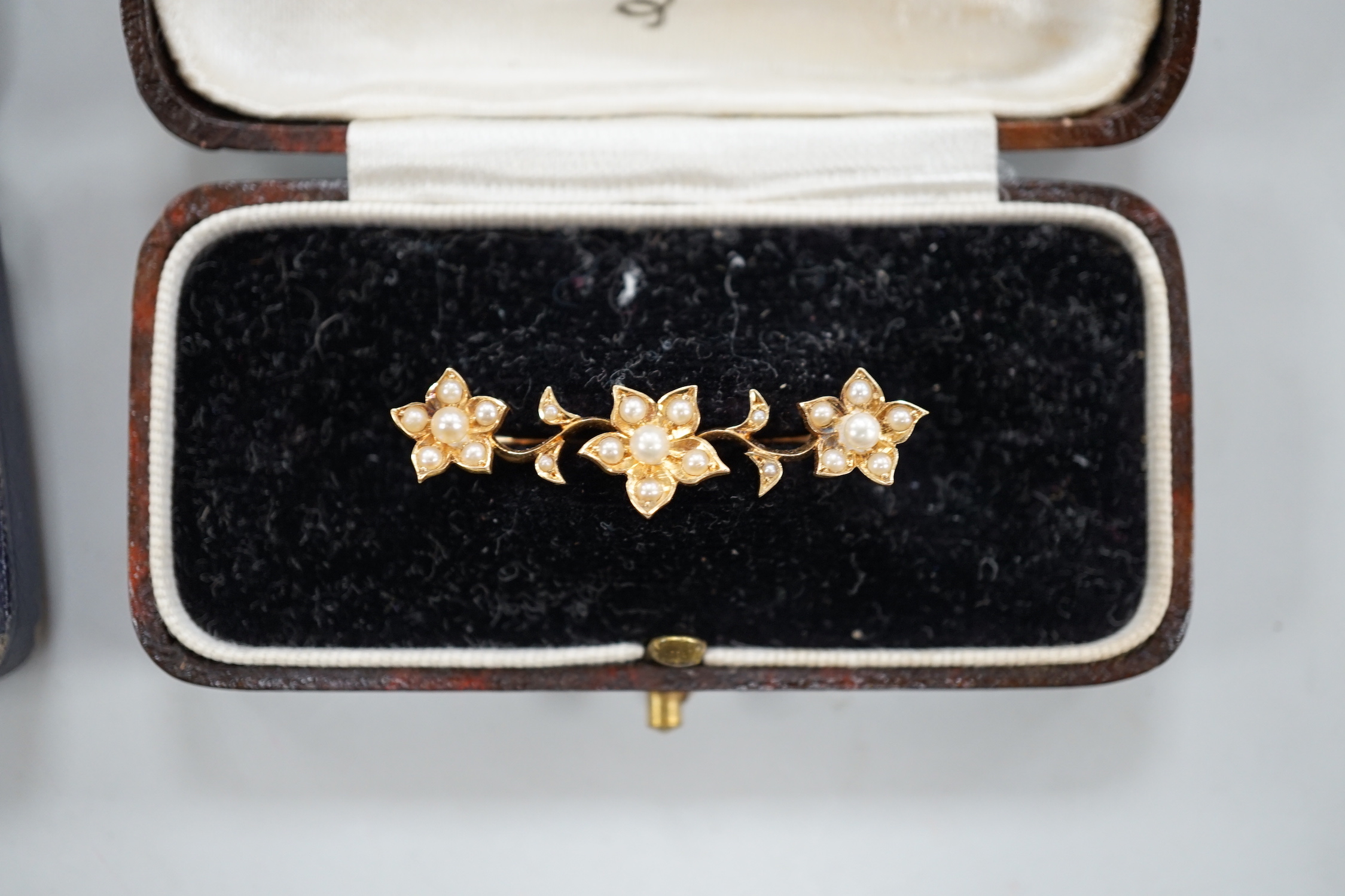 An Edwardian 15ct gold and seed peal set heart drop bar brooch, 40mm, gross weight 2.7 grams, two other yellow metal and gem set bar brooches and a Victorian citrine set brooch.